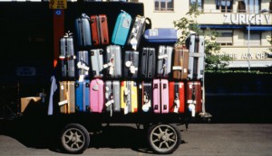 Luggage cart stacked with suitcases